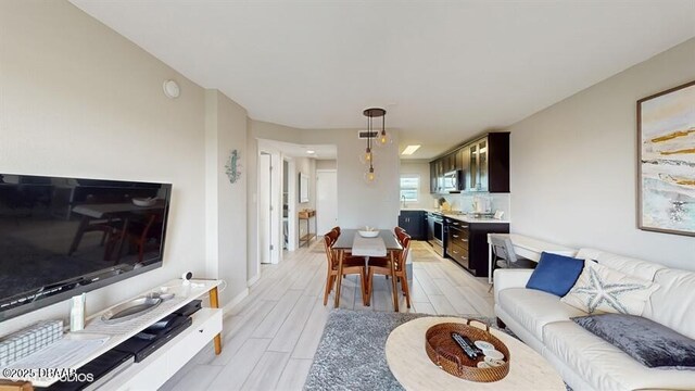 3170 Ocean Shore Blvd Unit 105, Ormond Beach, FL 32176 - living room featuring wood tiled floors and baseboards