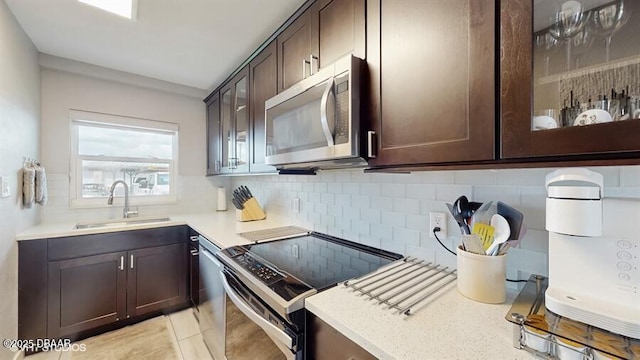 3170 Ocean Shore Blvd Unit 105, Ormond Beach, FL 32176 - kitchen featuring stainless steel microwave, black range with electric cooktop, dark brown cabinetry, and tasteful backsplash