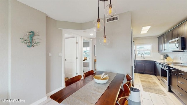 3170 Ocean Shore Blvd Unit 105, Ormond Beach, FL 32176 - dining space with light wood-style flooring