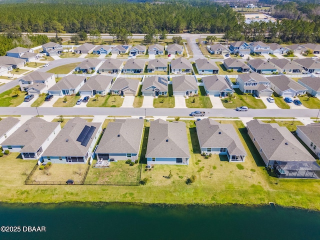 drone / aerial view featuring a residential view and a water view