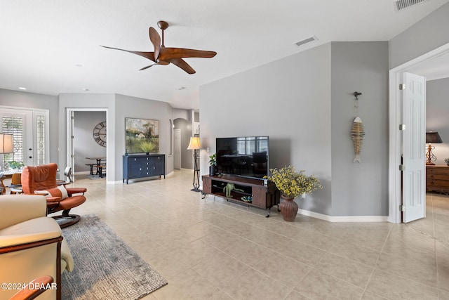 living room with ceiling fan and light tile patterned flooring