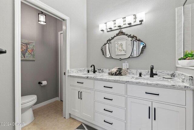 bathroom featuring toilet, vanity, and tile patterned floors