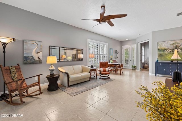 living room with ceiling fan and light tile patterned floors