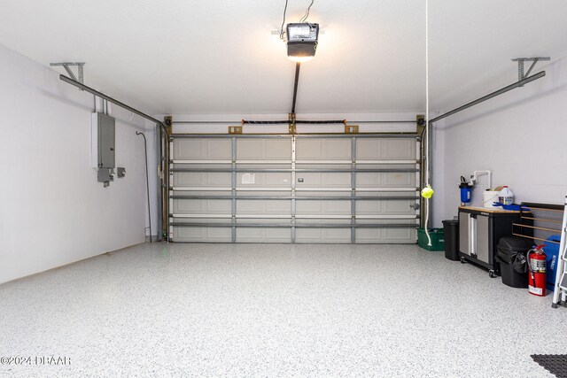 garage featuring a garage door opener and electric panel