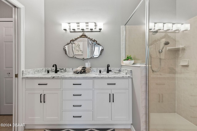 bathroom featuring a shower with door and vanity