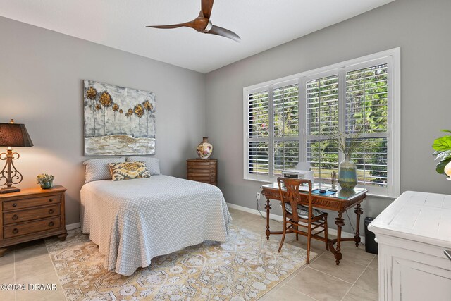 tiled bedroom featuring ceiling fan