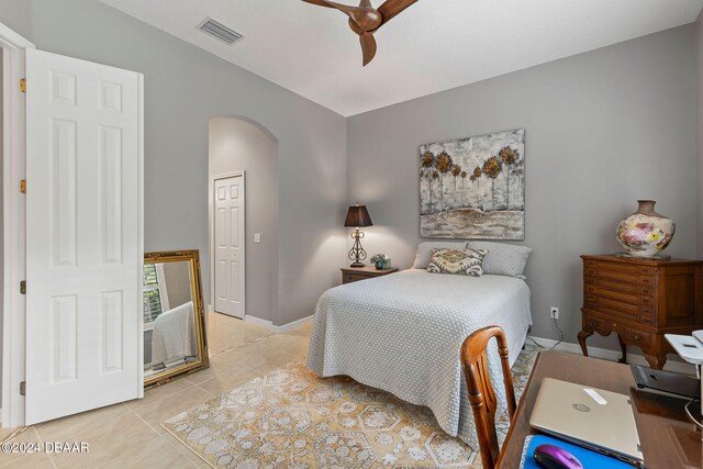 bedroom featuring light tile patterned flooring, ceiling fan, a closet, and lofted ceiling