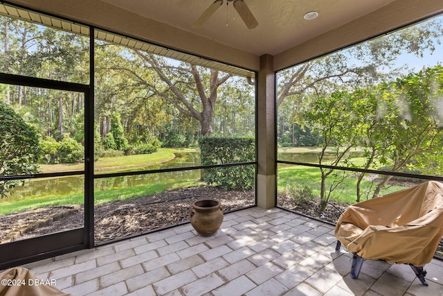 unfurnished sunroom featuring ceiling fan