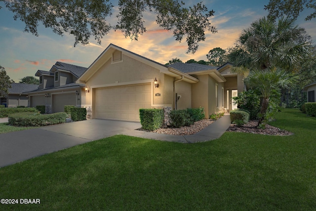 view of front facade with a garage and a yard