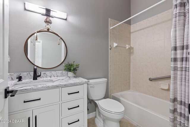 full bathroom featuring tile patterned floors, vanity, shower / bath combo with shower curtain, and toilet