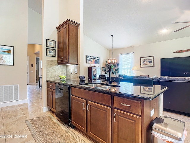 kitchen featuring dark stone counters, dishwasher, decorative backsplash, light tile patterned floors, and pendant lighting