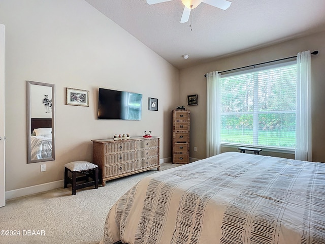 bedroom with ceiling fan, a textured ceiling, lofted ceiling, and carpet floors