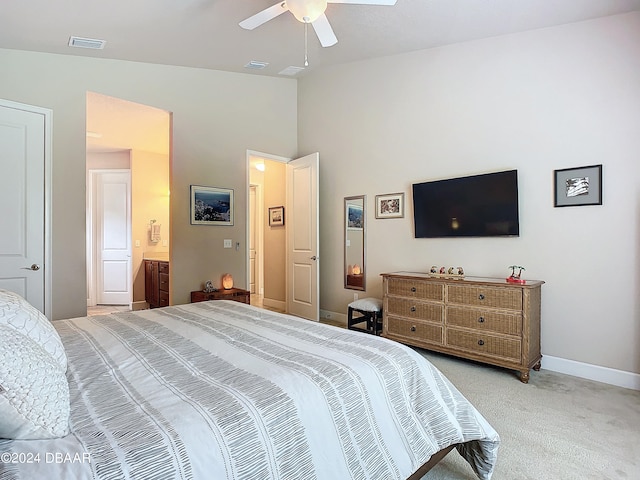 bedroom featuring lofted ceiling, light colored carpet, ceiling fan, and ensuite bathroom