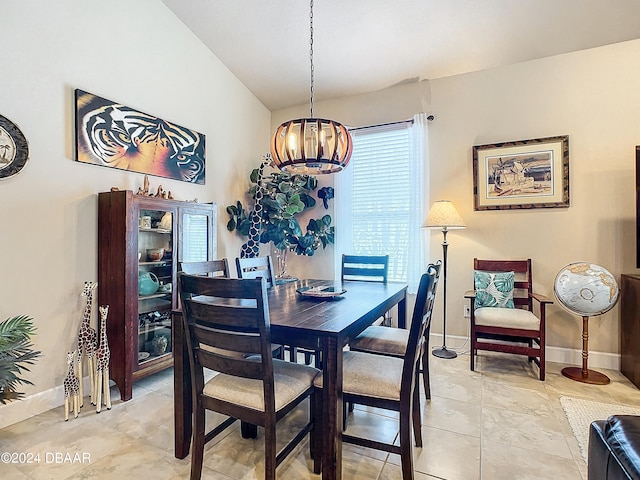 dining room with an inviting chandelier and lofted ceiling