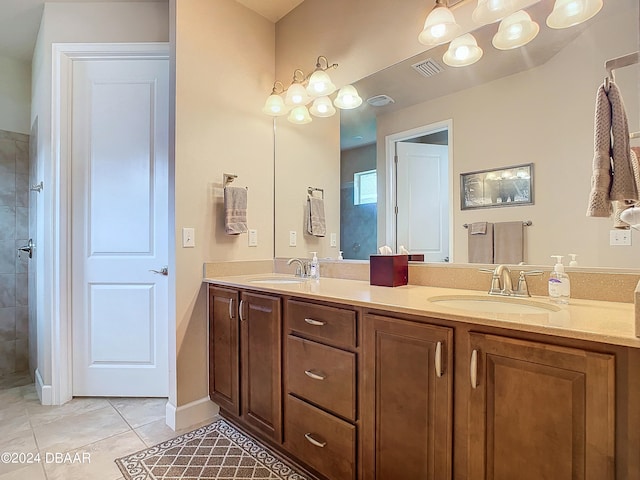 bathroom featuring vanity, walk in shower, and tile patterned floors