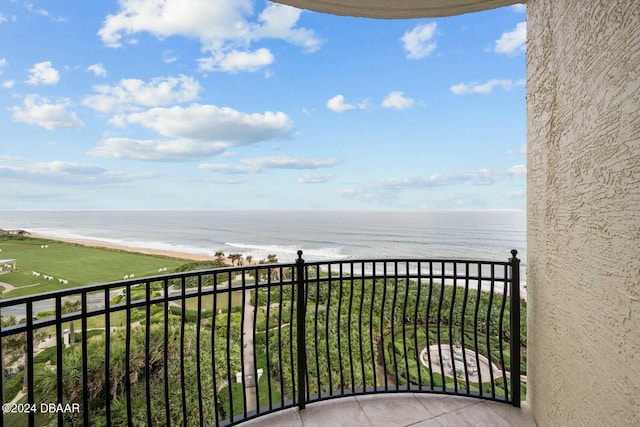 balcony with a water view and a beach view