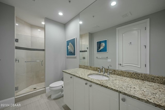 bathroom with tile patterned floors, vanity, toilet, and an enclosed shower