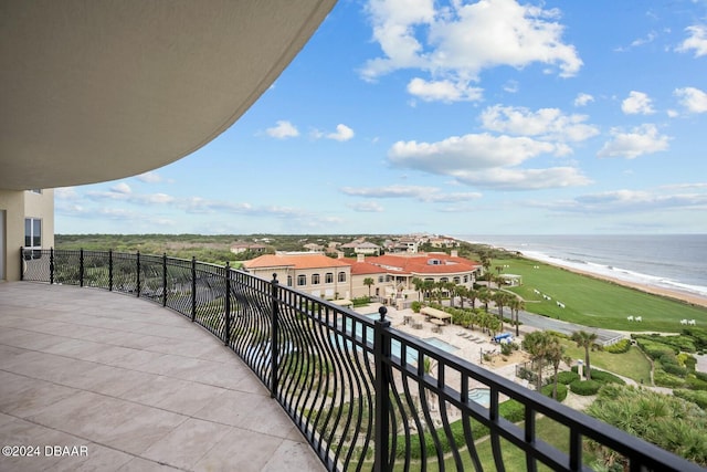 balcony featuring a water view and a beach view