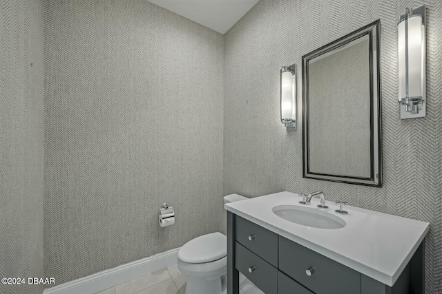 bathroom with tile patterned flooring, vanity, and toilet