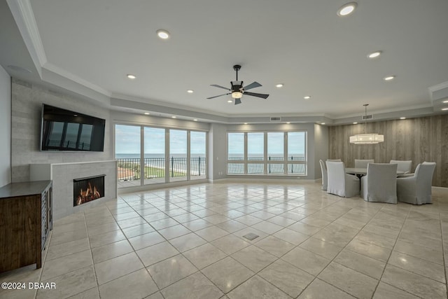 living room featuring ceiling fan, plenty of natural light, crown molding, and light tile patterned floors