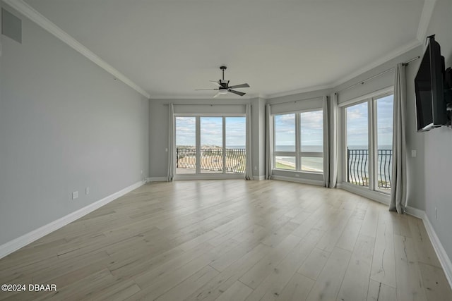 spare room featuring light hardwood / wood-style floors, ceiling fan, and crown molding