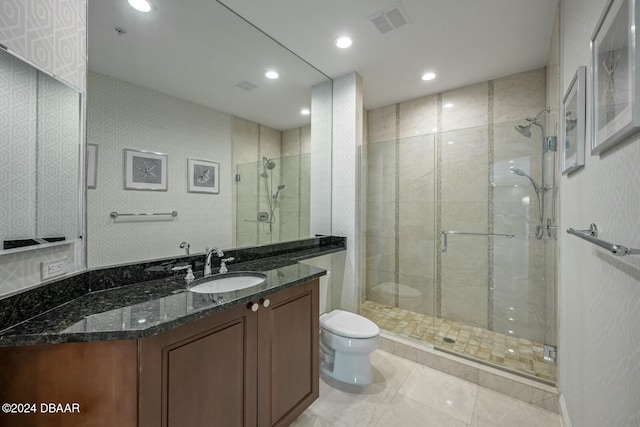 bathroom featuring tile patterned flooring, vanity, toilet, and a shower with shower door