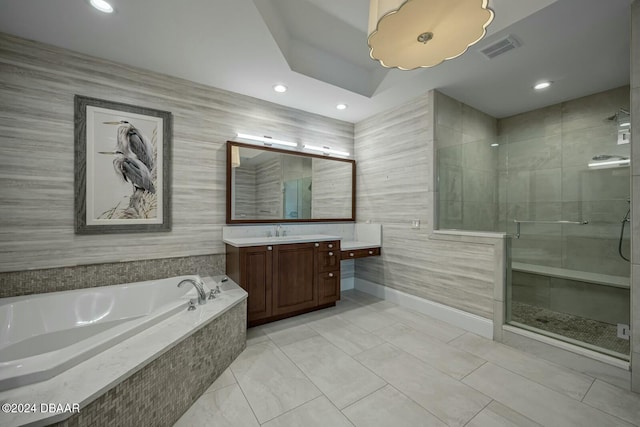 bathroom with vanity and independent shower and bath