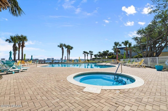 view of swimming pool with a hot tub and a patio area