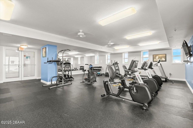 gym featuring french doors, a wealth of natural light, and a textured ceiling