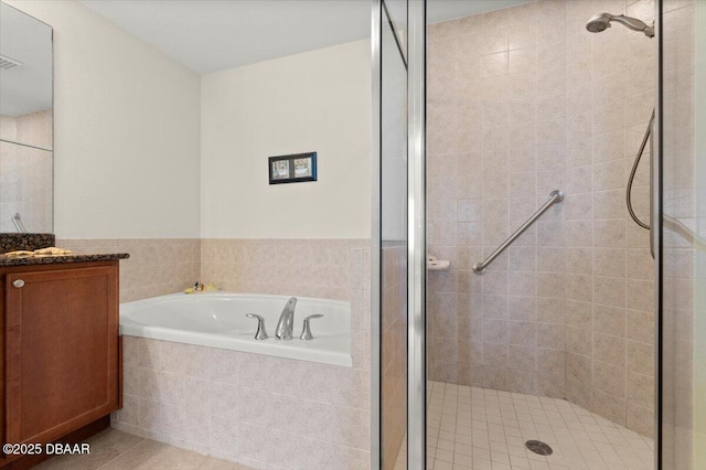 bathroom featuring separate shower and tub, vanity, and tile patterned floors