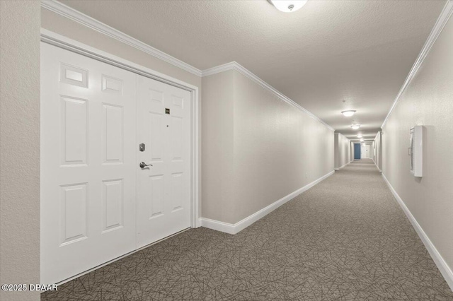 interior space featuring a textured ceiling, dark colored carpet, and crown molding