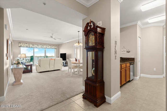 hallway with a notable chandelier, crown molding, and light carpet