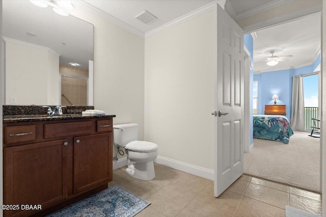 bathroom with toilet, vanity, walk in shower, and crown molding