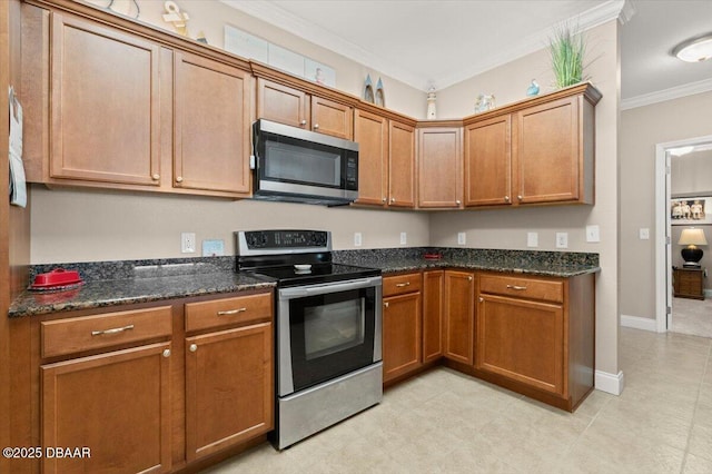 kitchen featuring stainless steel appliances, crown molding, and dark stone counters