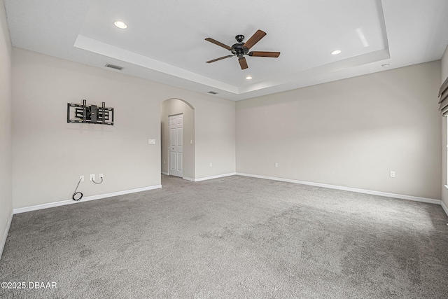 10 Creek Ct, Palm Coast, FL 32137 - carpeted empty room with visible vents, a tray ceiling, arched walkways, recessed lighting, and a ceiling fan