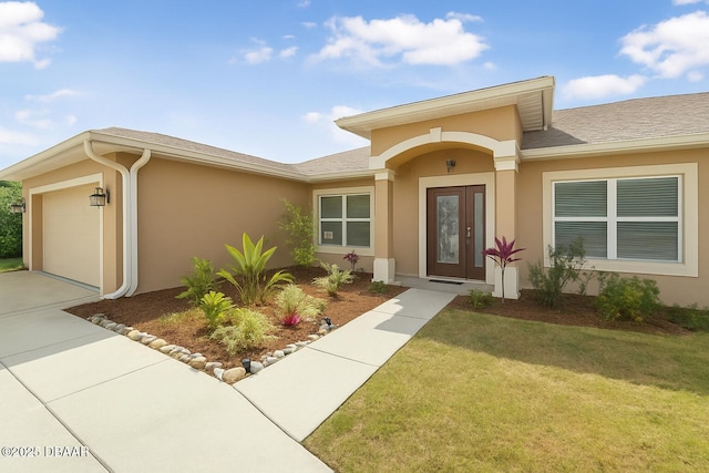 10 Creek Ct, Palm Coast, FL 32137 - property entrance featuring a yard, stucco siding, concrete driveway, and an attached garage