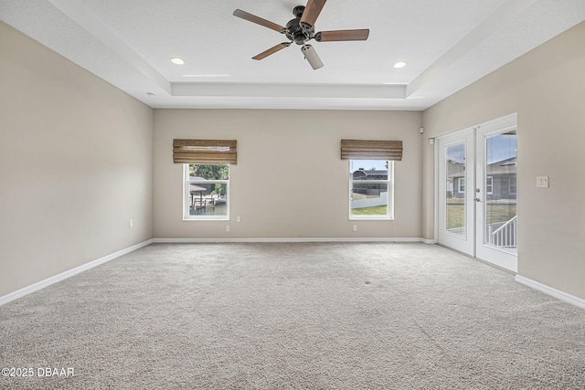10 Creek Ct, Palm Coast, FL 32137 - carpeted empty room with a raised ceiling, ceiling fan, french doors, and baseboards