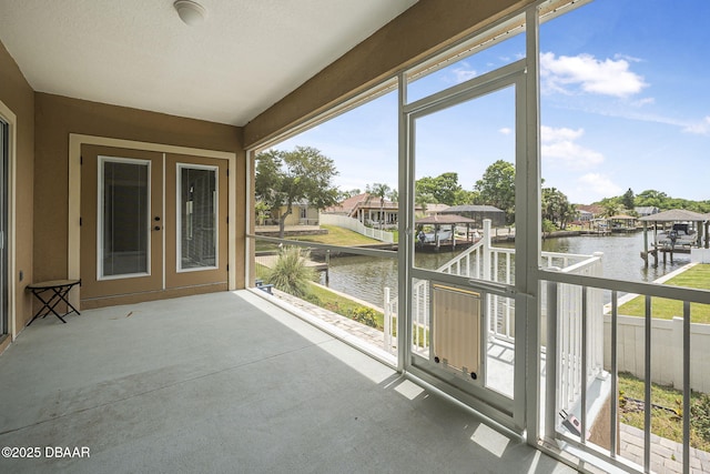 10 Creek Ct, Palm Coast, FL 32137 - unfurnished sunroom featuring a water view and french doors
