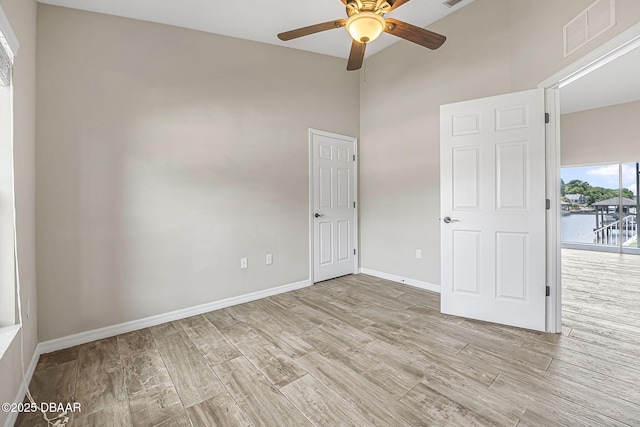 10 Creek Ct, Palm Coast, FL 32137 - unfurnished room with wood finished floors, visible vents, ceiling fan, and baseboards