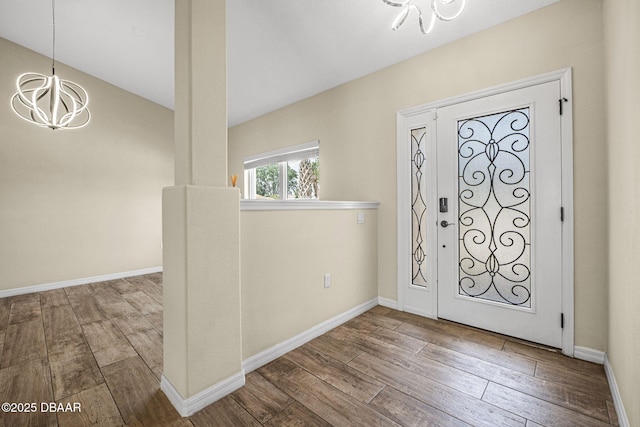 10 Creek Ct, Palm Coast, FL 32137 - foyer with wood-type flooring, a notable chandelier, and baseboards