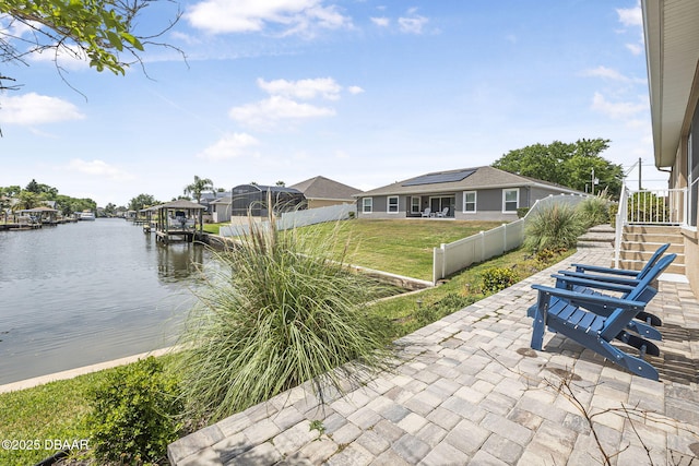 10 Creek Ct, Palm Coast, FL 32137 - view of patio with boat lift, fence, a boat dock, and a water view