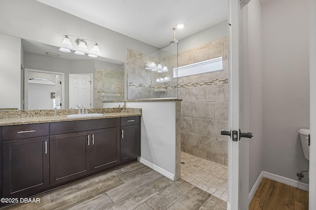 10 Creek Ct, Palm Coast, FL 32137 - full bath with baseboards, walk in shower, toilet, wood finished floors, and vanity