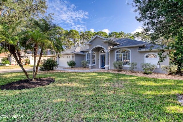 view of front of house with a front lawn and a garage