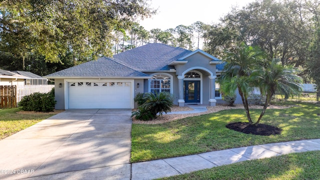 ranch-style home featuring a front lawn and a garage