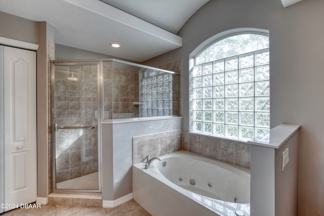 bathroom featuring tile patterned flooring, a textured ceiling, and separate shower and tub