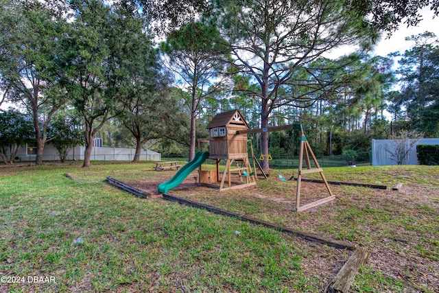 view of playground with a lawn