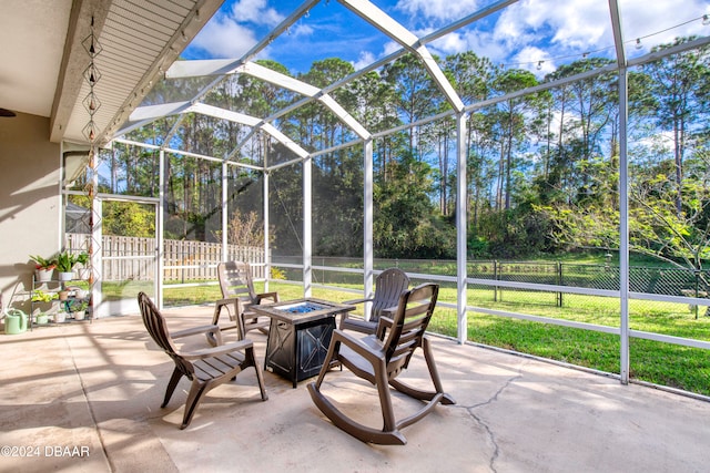 view of patio / terrace with glass enclosure and a fire pit