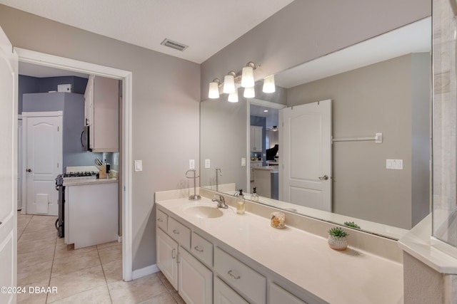 bathroom with tile patterned flooring and vanity