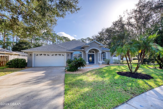 ranch-style home with a front yard and a garage