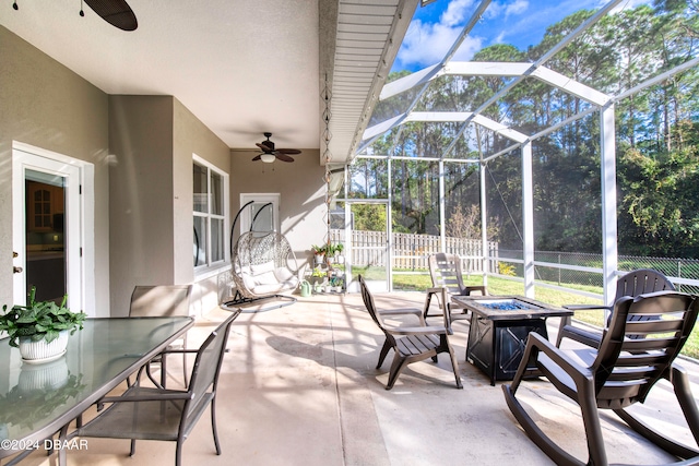 view of patio / terrace with ceiling fan and a lanai